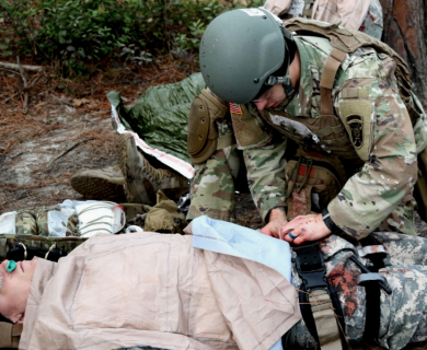Soldier applying pressure to a wound to stop bleeding