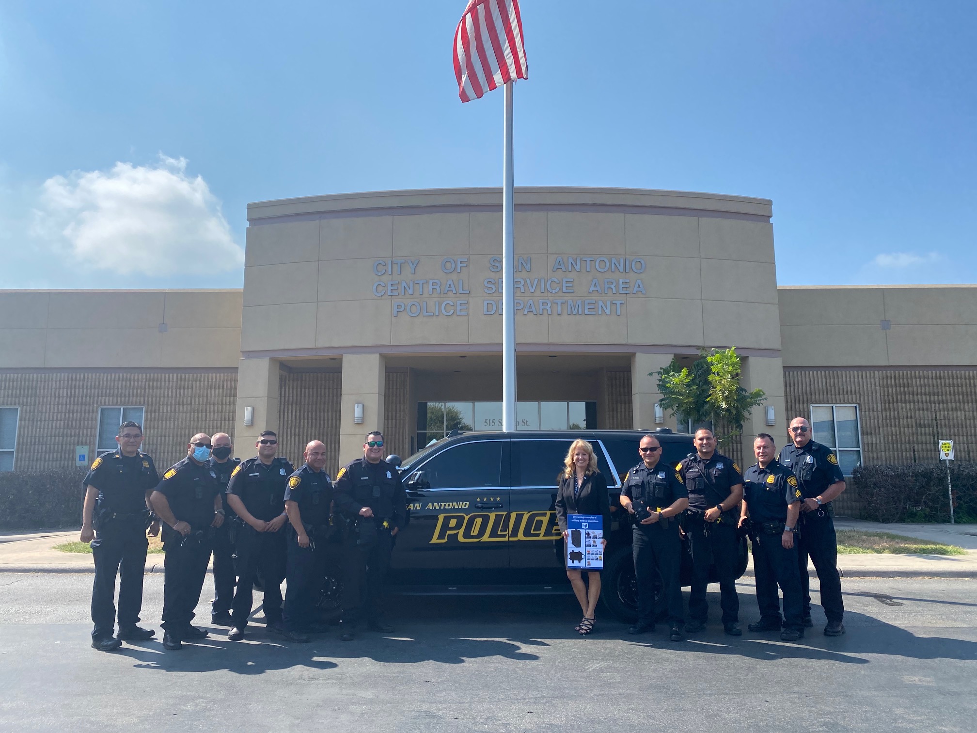 Betsy Folk with San Antonio Police Officers with PD building in background