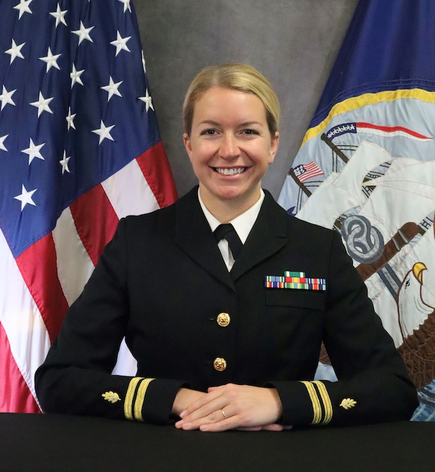 Caucasian female with blonde hair in navy uniform 