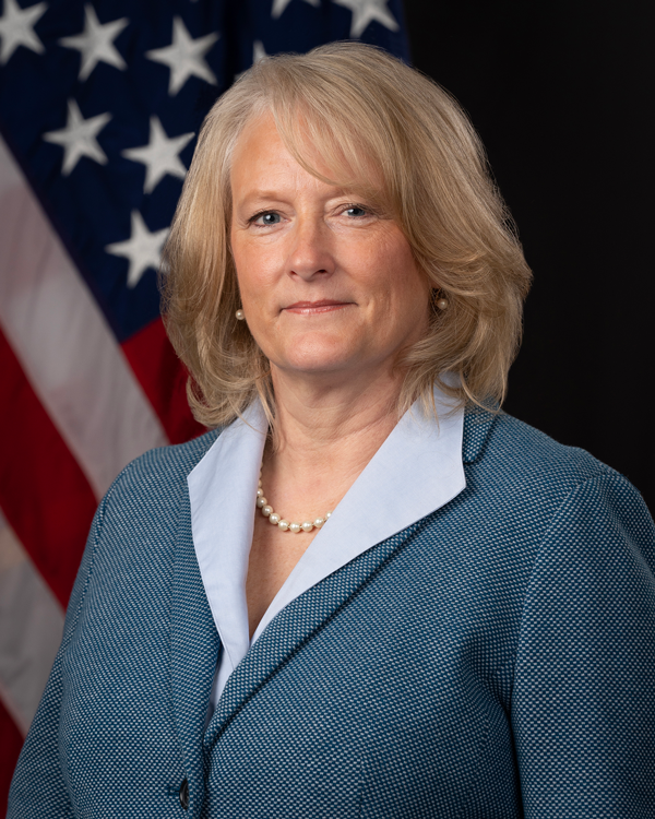 Caucasian woman in front of American Flag