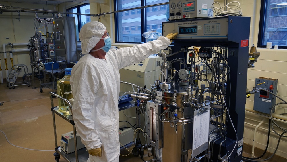 a person working at a machine in a laboratory 