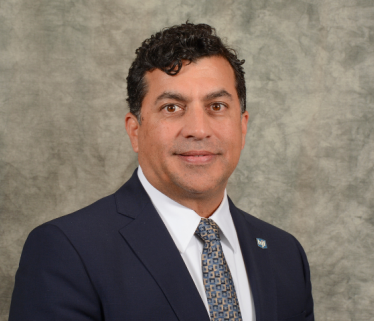 photo of doctor Stephen Dalal mixed race man executive in business suit