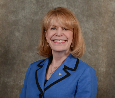 Photo of Cynthia Gilman, mature white woman executive in blue suit