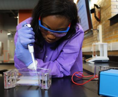 Female scientist works with pipette and culture