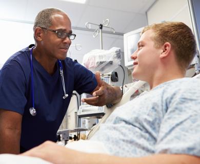 Doctor and Patient engage while Patient lays down