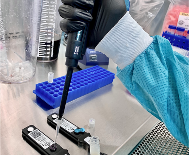 gloved hand uses autopipetter to insert sample in a lightdeck assay gloved hand uses autopipetter to insert sample in a lightdeck assay