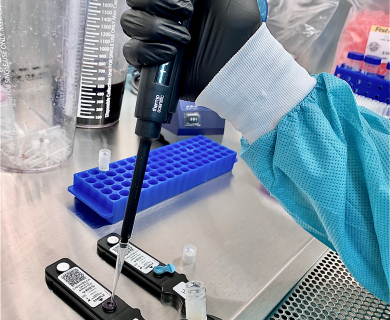 gloved hand uses autopipetter to insert sample in a lightdeck assay