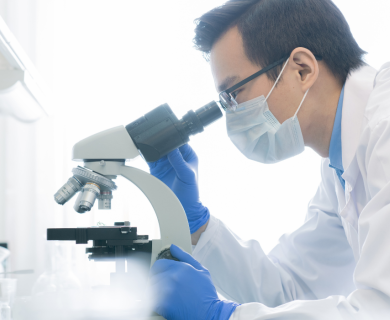 Man looking in microscope 