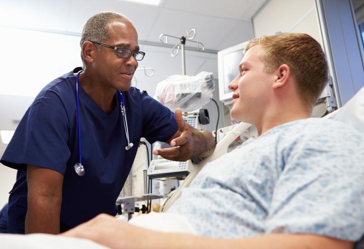 Doctor and Patient engage while Patient lays down