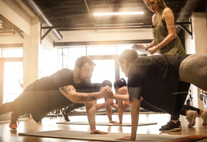 Three people engage in exercise Three people engage in exercise
