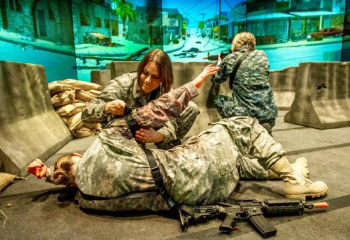 Troops practice a simulation of wounded and medic.