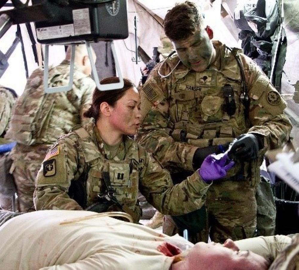 Two soldiers reading medical instructions