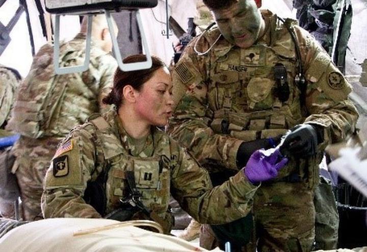 Two soldiers reading medical instructions