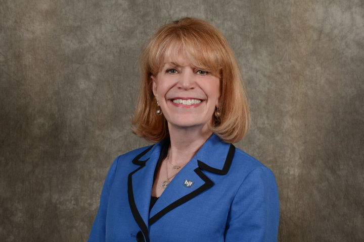 Photo of Cynthia Gilman, mature white woman executive in blue suit