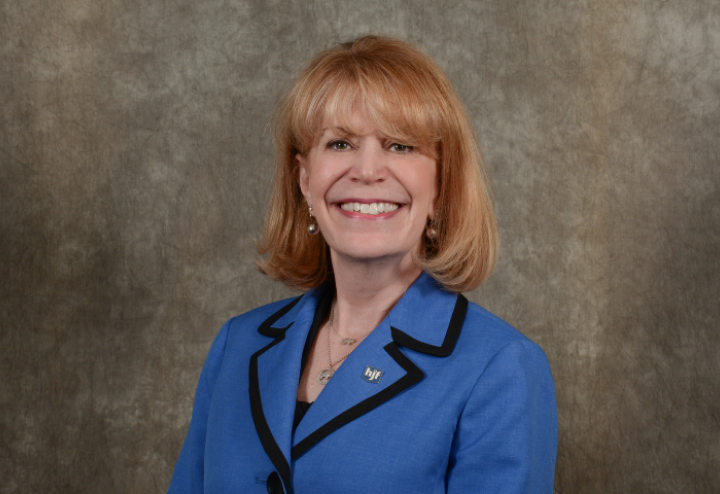 Photo of Cynthia Gilman, mature white woman executive in blue suit