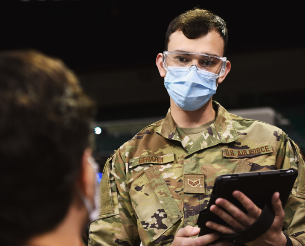 Man in US Air Force uniform stands with tablet in his hand